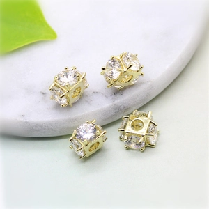 Close-up of 14K gold plated hollow beads with clear cubic zirconia for DIY jewelry