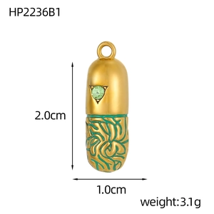 Detail view of a gold capsule pendant with green gemstone and 2.0cm size measurement label