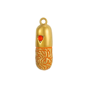 Detail of capsule-shaped stainless steel pendant with red gem and orange texture