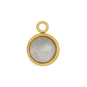 Macro detail of round white gemstone pendant with golden bezel setting in retro style
