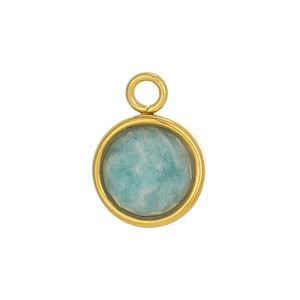 Detailed macro view of a bohemian round turquoise pendant with gold plated brass edge