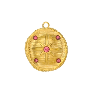Detail of vintage gold tarot pendant with pink zircon starburst and hammered texture
