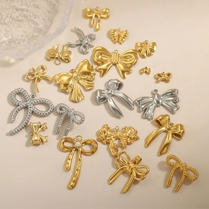 Pendentifs papillons élégants en or et argent aux textures variées sur fond beige clair