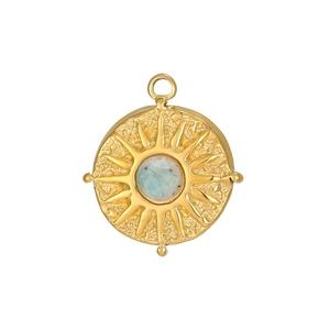 Detail of vintage round sunburst pendant with zircon stone and hammered metal finish