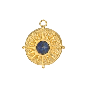 Macro detail of sunburst tarot pendant with gold hammering and blue zircon center