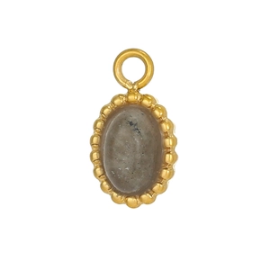 Macro shot of oval gold-plated pendant with semi-transparent grey gemstone and bead-edge detail