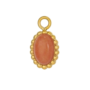 Detail of vintage bohemian oval gold pendant with micro-set carnelian gemstone