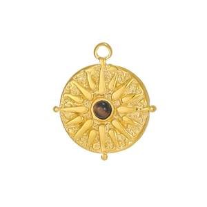 Detail of vintage round tarot pendant with sunburst relief and tiger eye stone