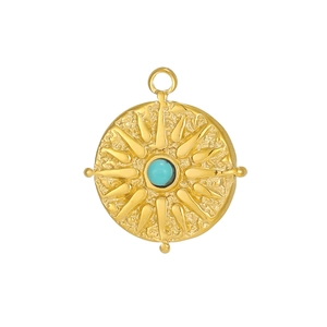Macro detail of gold tarot sun pendant with turquoise inlay and hammered texture finish