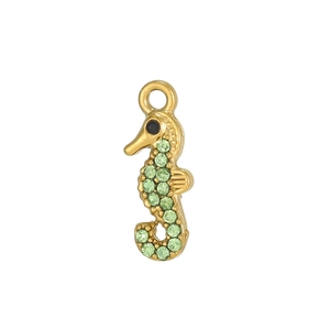 Macro detail of gold seahorse pendant with pavé-set green zircons and polished finish