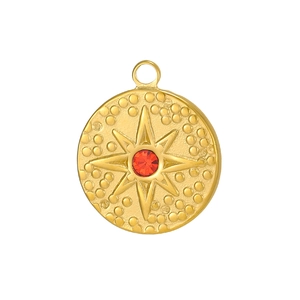 Close-up of gold stainless steel tarot charm with red zircon and starburst relief detail