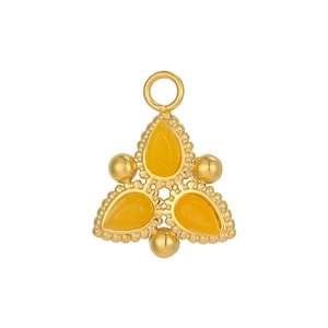 Detail of vintage bohemian pendant with yellow stones and gold plated steel texture