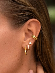 Detailed view of layered 18k gold plated stainless steel heart hoop and stud earrings