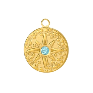 Detail of vintage round star pendant with light blue zircon and embossed celestial patterns