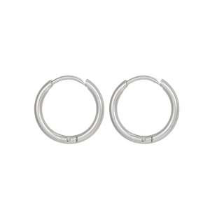 Detailed macro view of silver geometric 18K gold-plated stainless steel hoop earrings