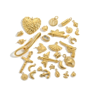 Collection of golden stainless steel DIY charms in various creative shapes with polished finish