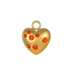 Détail d'un pendentif coeur doré avec cristaux oranges pour la création de bijoux DIY
