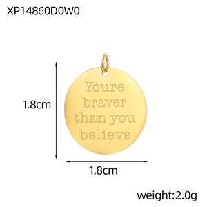 Detailed view of circular gold pendant with motivational engraving and 1.8cm diameter scale