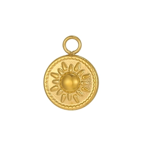 Detailed macro view of a golden circular pendant featuring a radiant sun relief design