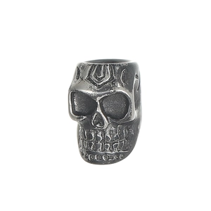 Macro detail of gothic skull bead showing oxidized stainless steel texture and facial carvings