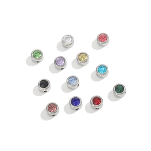 Detail of 12 multi-colored birthstone charms with stainless steel base for DIY jewelry