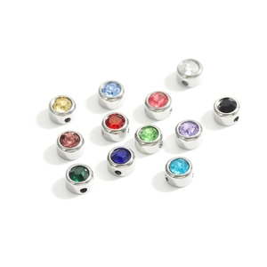 Macro shot of 12 birthstone charms with polished finish and colorful rhinestones