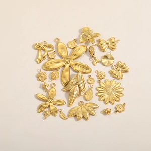 Macro shot of gold vacuum-plated stainless steel flower and sunflower DIY jewelry charms