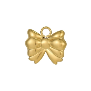 Detailed view of a golden bow-shaped charm with a metal loop for DIY jewelry making