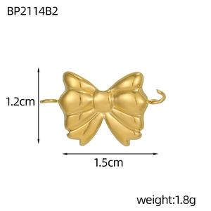 Macro shot of 1.5cm gold bow charm connector in polished stainless steel for DIY jewelry