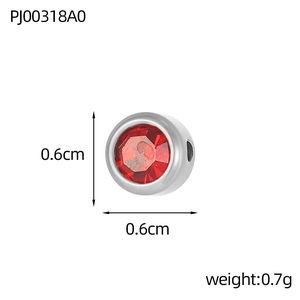 Macro shot of a 6mm round red birthstone charm in stainless steel for DIY jewelry