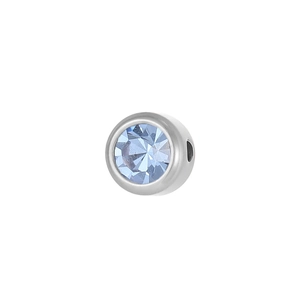 Macro view of a 6mm silver stainless steel charm with a faceted light blue birthstone
