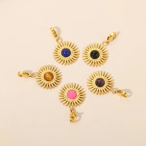 Detailed view of five sunburst pendants with colorful stones and lobster clasps
