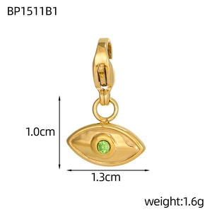 Macro shot of gold Evil Eye heart pendant with green gem and dimensions 1.0x1.3cm