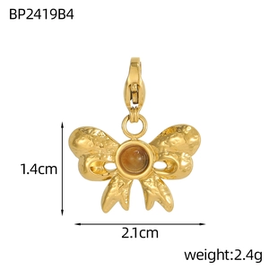 Detailed macro view of bow charm with hammered texture and amber stone inlay