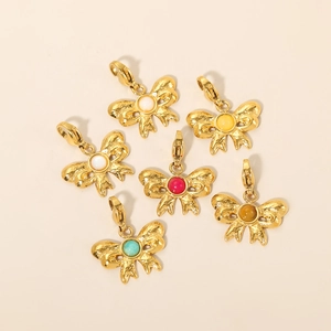Macro detail of retro bow charms with colorful natural stones and hammered metal texture