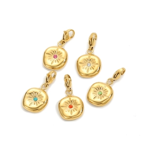 Detailed view of five gold sunburst tarot pendants with colorful central rhinestones