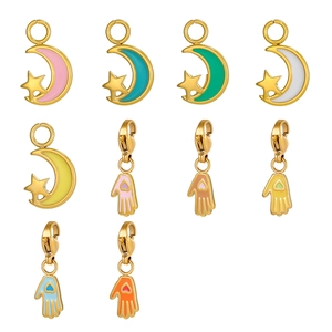 Detail of colorful enamel star moon and Hamsa hand pendants with lobster clasps