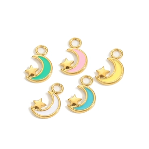 Detailed view of five colorful enamel star and moon charms with gold lobster clasps