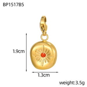 Detailed view of tarot sunburst gold pendant with red gemstone inlay and size labels