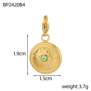 Macro shot of gold Evil Eye heart pendant with green gem and dimensions 1.9cm by 1.5cm