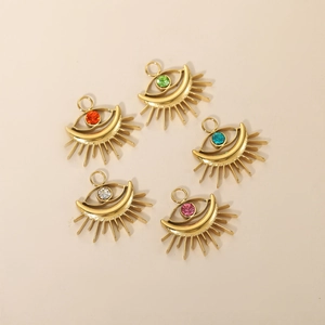 Detailed macro of golden evil eye pendants with multi-colored crystals and metal rings