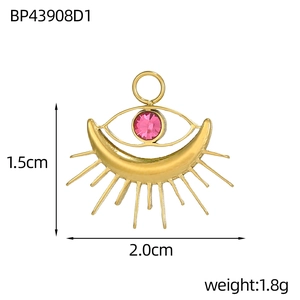 Detailed view of tarot evil eye pendant with pink crystal and golden moon accents