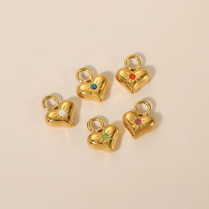 Dettaglio di cinque ciondoli a cuore in oro con pietre di zirconi cubici multicolori