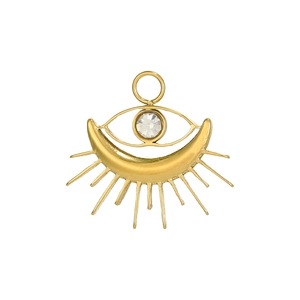 Detail of a golden tarot heart necklace with evil eye and crescent moon design