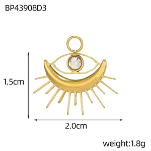 Detail of gold heart tarot pendant with crescent moon, evil eye, and crystal, 2.0x1.5cm size