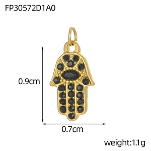 Detailed view of gold Hamsa Hand pendant with black zircons and size markings