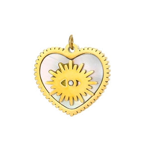 Macro shot of heart-shaped shell pendant with gold evil eye sunburst and zircon inlay