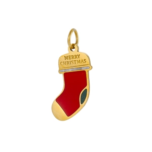 Macro shot of gold-plated Christmas sock pendant with Merry Christmas engraving