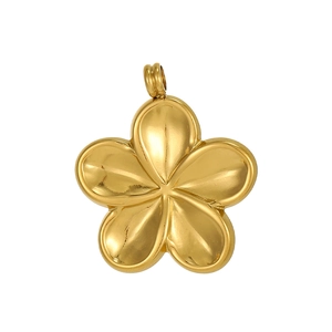 Macro view of gold-plated plumeria flower pendant with polished metallic finish