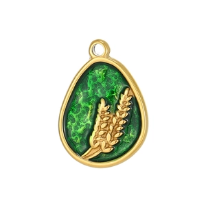 Macro detail of irregular green enamel pendant with golden wheat ear relief pattern